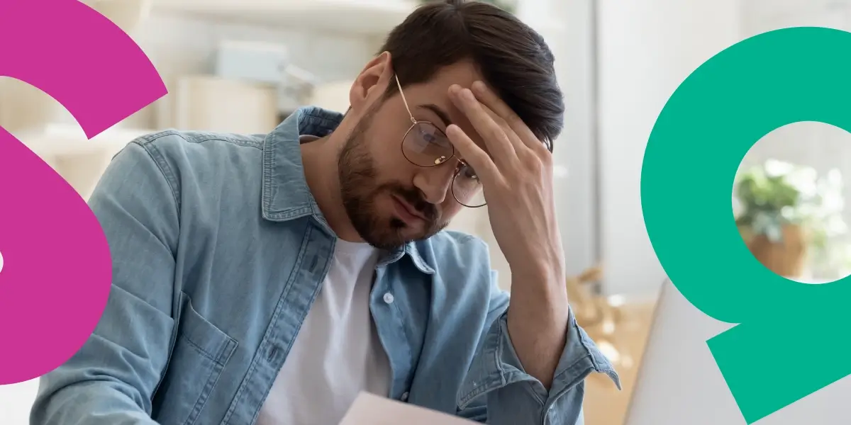 Man reading a letter with his hand on his head