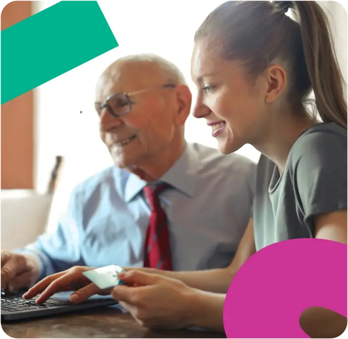 Older man and younger woman using a laptop computer